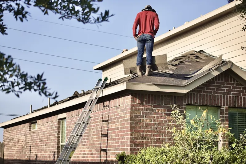 Professional roofer working on a residential roof in Sage Creek